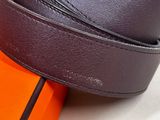 a close up of a brown belt on top of an orange box