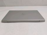 the laptop is sitting on a white surface with a white background