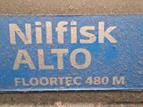 a blue sign that says nilfisk alto on the side of the road