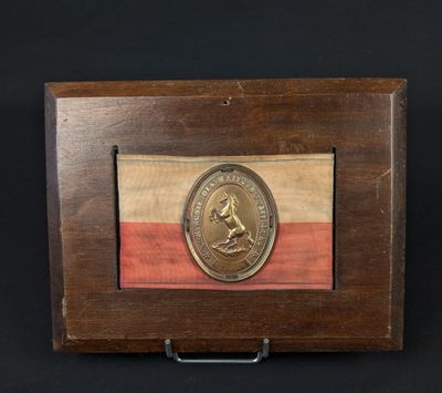 a wooden box with a gold medal on top of it
