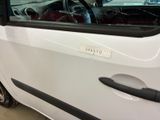 a small white car parked in a parking lot