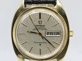 an image of a gold watch with a black leather strap