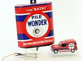 a small toy car next to a can of pill wonder