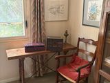 a chair and a table in a room with a window