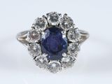 gros plan d'une bague en saphir bleu et diamant sur une surface blanche