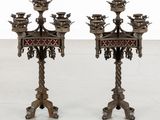 pair of antique brass candelabs with red and black designs