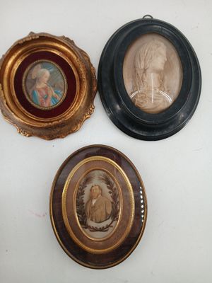 three framed pictures of a woman and a child in a gold frame