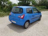 a small blue car parked in a parking lot