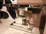 a mirrored desk with a mirror top and a mirror shelf