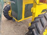a tractor that is parked next to a fence