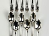 a lot of spoons and forks on the table