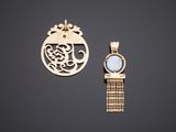 two gold pendants, one with a blue stone and the other with a gold chain