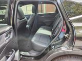 the interior of a car with the door open and the passenger seat down