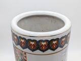 a white vase with colorful designs on it on a white surface