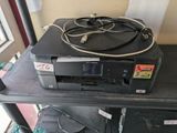 a black printer sitting on top of a black table