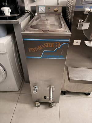 a machine that is sitting in a kitchen next to a washer