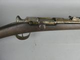 an old gun with a metal handle and a wooden handle