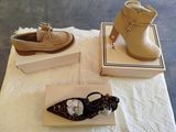 two pairs of women ' s shoes and a box on a table