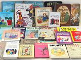 a lot of children ' s books that are on the table