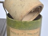 a canister with a wooden handle and a book in it