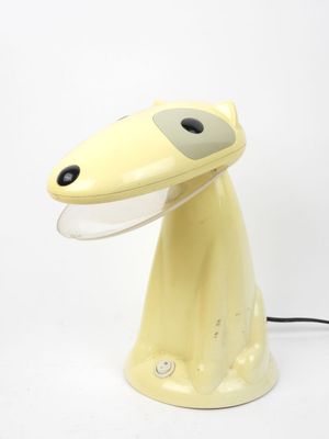 a yellow lamp that is sitting on a table