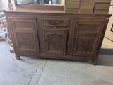a wooden cabinet with a mirror on top of it