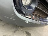 a close up of the front of a car with a dent in it