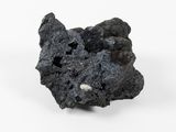 a piece of black rock that is on a white surface