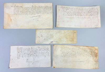 four pieces of paper with writing on them on a blue surface