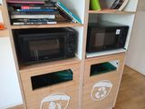 a microwave and a microwave oven on a wooden shelf