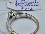 a ring with a diamond on it sitting on a table