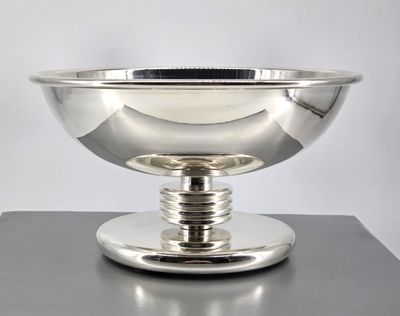 an image of a silver bowl sitting on top of a table