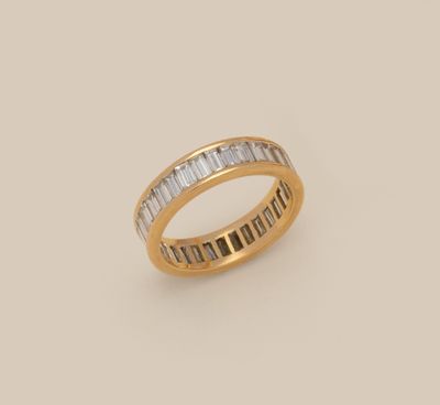 an 18k yellow gold ring with baguets of diamonds