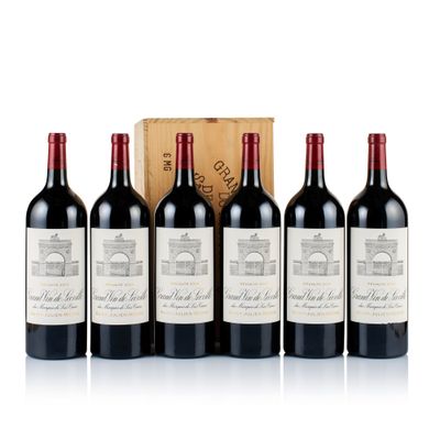 six bottles of red wine are lined up in front of a wooden box