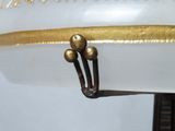 a close up of a white vase with gold decorations on it