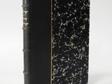 a black and gold book with a black cover on a white background