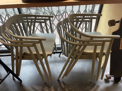 two chairs and a table with a vase on it