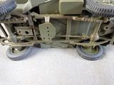 a close up of a toy army vehicle on a white surface