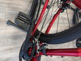 a bicycle that is laying on the floor next to a wheel