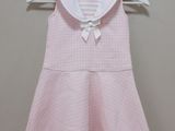 pink dress with white collar and bow on the chest