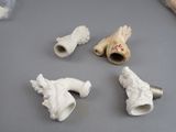 four pieces of white clay that are sitting on a table