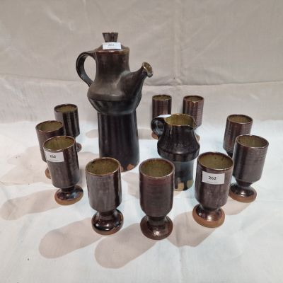 a lot of cups and a teapot on the table