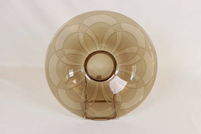 a brown glass bowl with a flower design on it