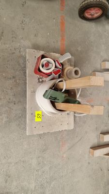 a pile of tools on the floor next to a pile of boxes