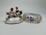 pair of porcelain figurines of a boy and a girl in a boat