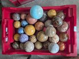a red basket filled with lots of different types of rocks