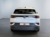 the rear view of a white volkswagen suv parked in a room
