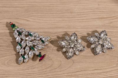 three pieces of jewelry sitting on top of a wooden table
