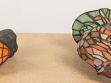 two colorful butterflies that are sitting on a table