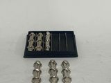 an image of a set of silver metal screws in a black box